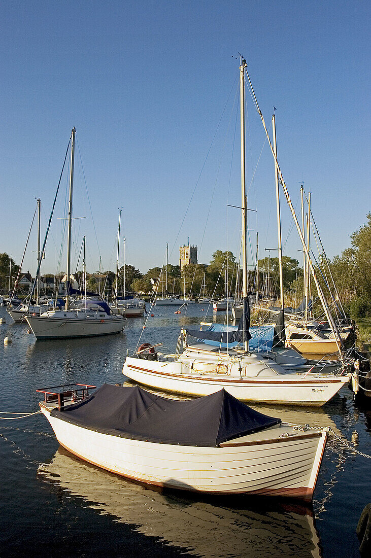 UK. Dorset. Christchurch. Priory church with moored leisure boats