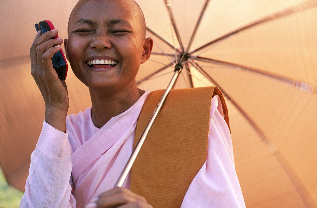Nun with mobile. Myanmar (Burma)