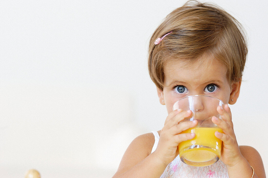 Litlle girl having a soft drink