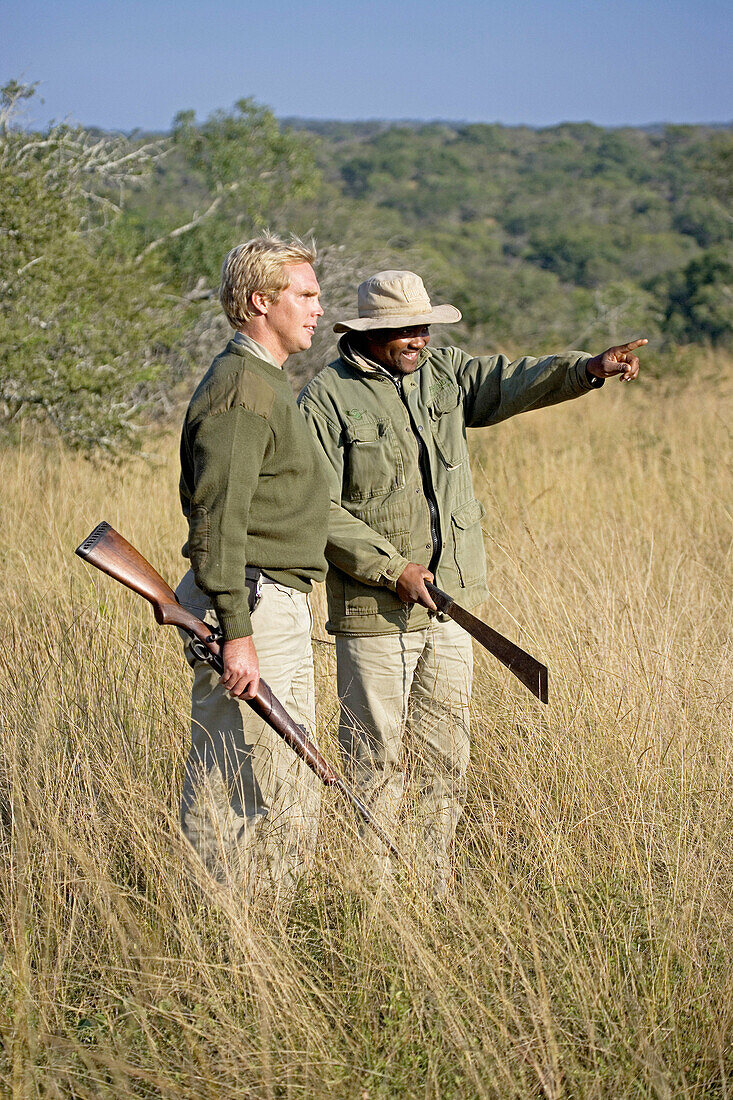 Park Rangers Ryan Kewley and Thomas Nsele. Game drive in the Phinda private park. Kwazulu-Natal province. South Africa