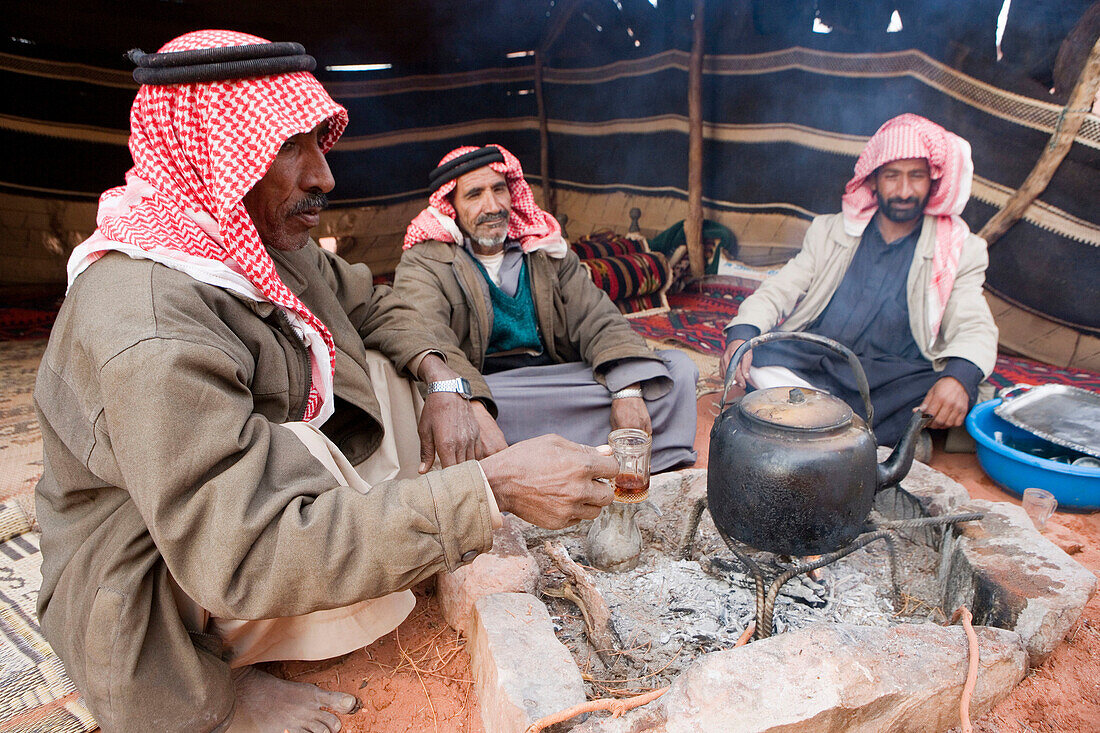 Bedouin men having tea. Wadi Rum desert. Kingdom of Jordan