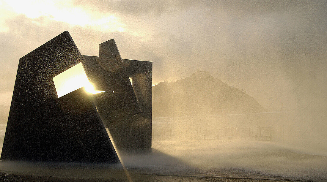 Sculpture by Jorge Oteiza and waves at Paseo Nuevo promenade. San Sebastián. Euskadi. Spain