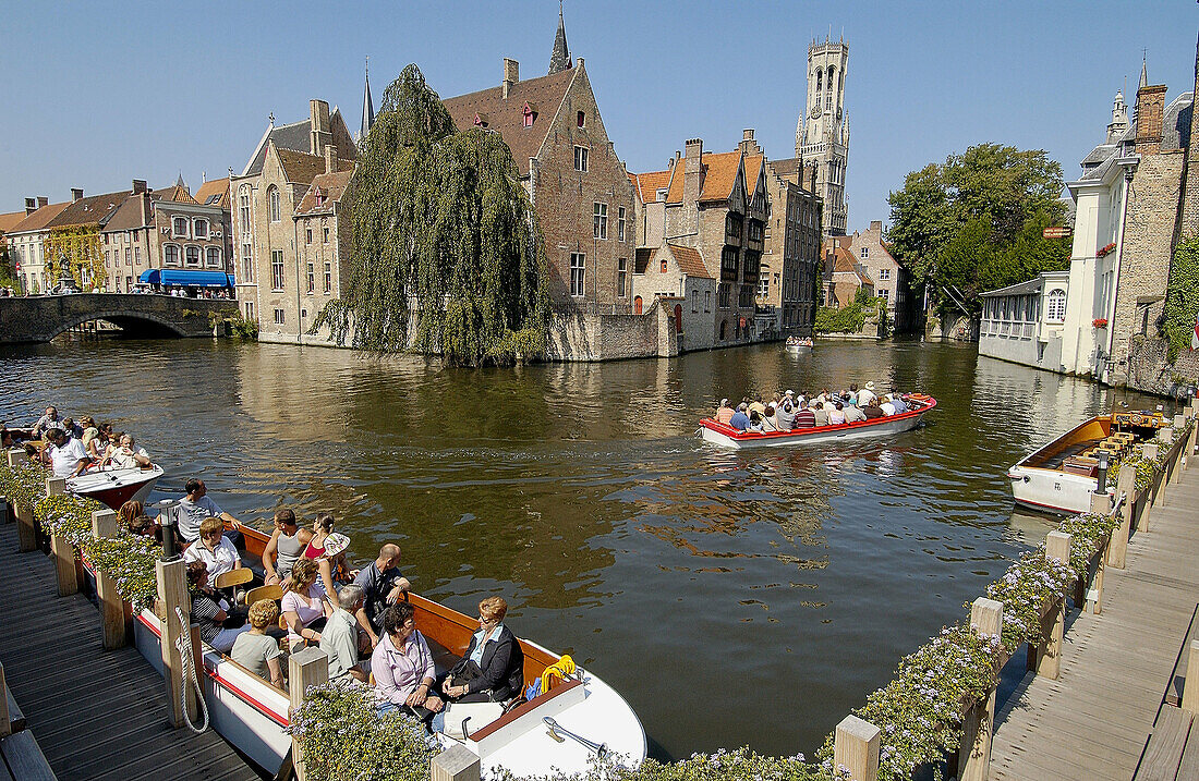 Tourists on boat by Groenerei and Rozenhoedkaai. Brugge. Flanders, Belgium