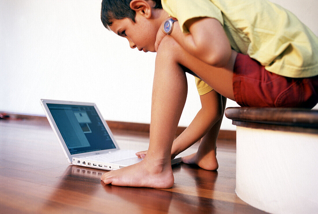 Child and laptop computer