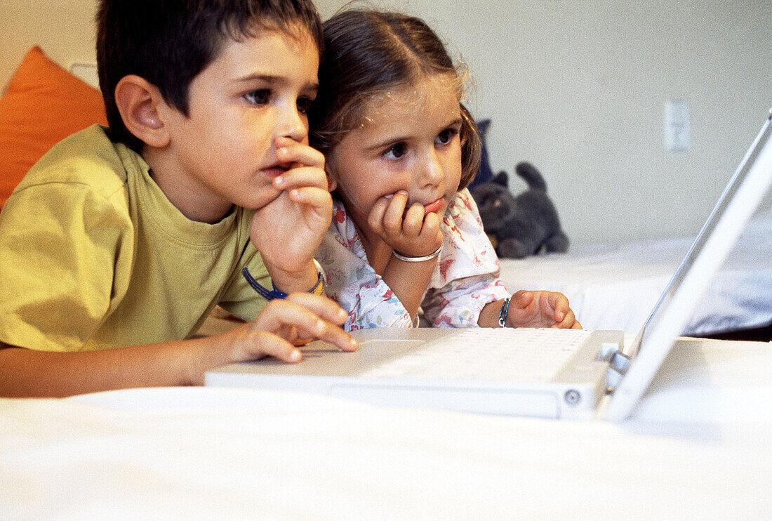 Children and laptop computer