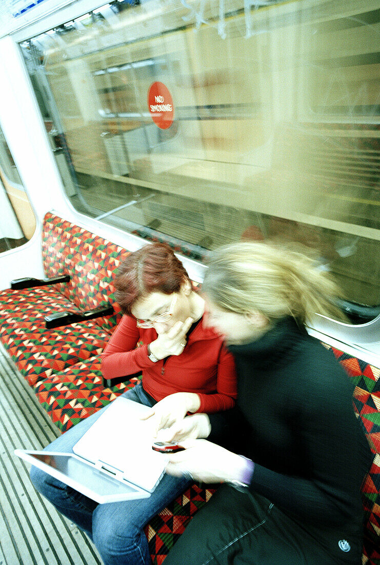Women with laptop in the tube