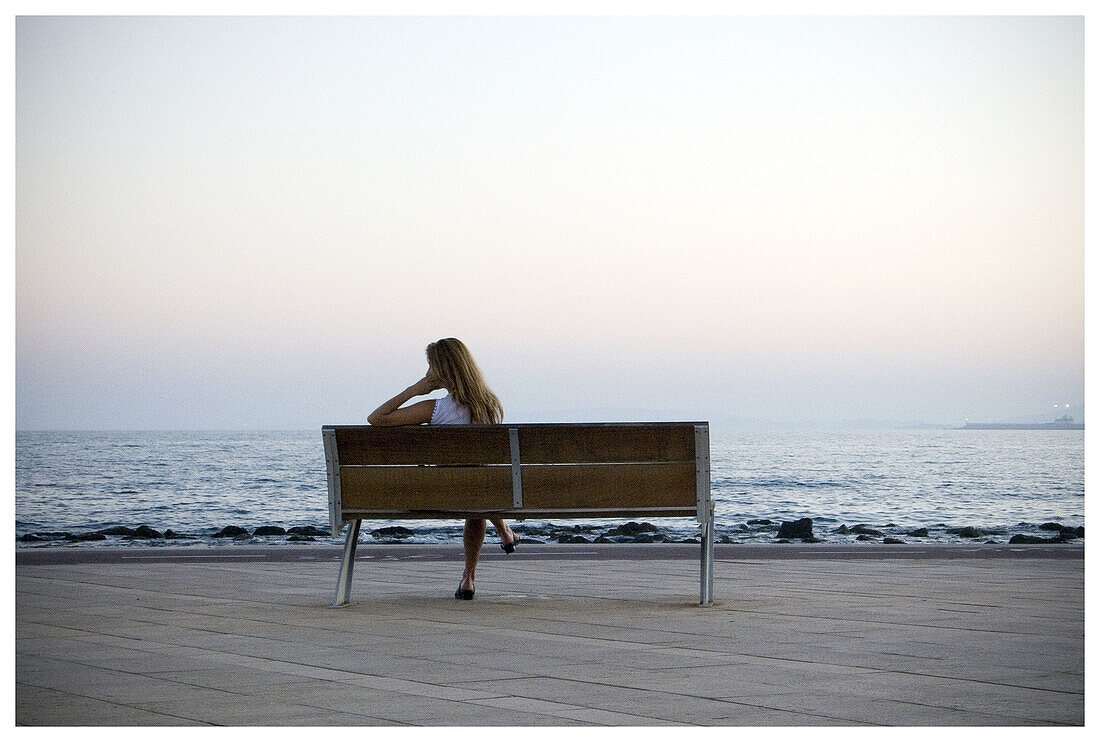  Adult, Adults, Back view, Bench, Benches, Blonde, Blondes, Coast, Coastal, Color, Colour, Contemporary, Daytime, Exterior, Fair-haired, Female, Horizon, Horizons, Human, Lean, Leaning, Lone, Loneliness, Lonely, Long hair, Long haired, Long-haired, One, O