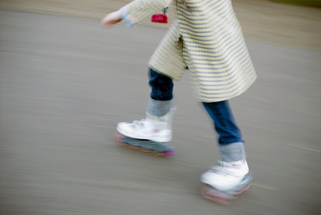 Girl skating. Hyde Park, London. England, UK