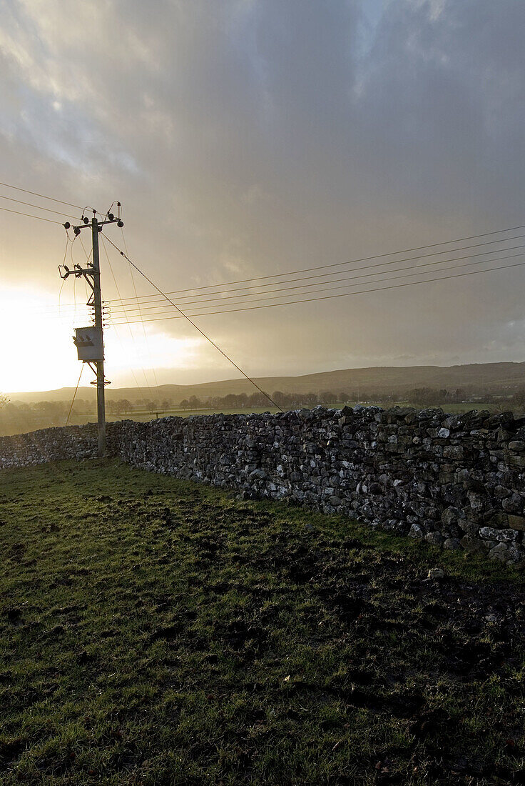  Color, Colour, Concept, Concepts, Country, Countryside, Daytime, Deserted, Electric power, Electricity, Evening, Exterior, One, Outdoor, Outdoors, Outside, Pole, Poles, Power line, Power lines, Rural, Scenic, Scenics, Silhouette, Silhouettes, Stone, Wall