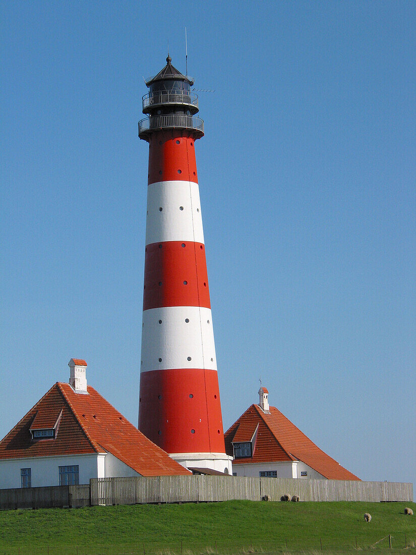 Lighthouse, salt meadow, tide. Westerhever, Schleswig-Holstein Wadden Sea National Park, Germany