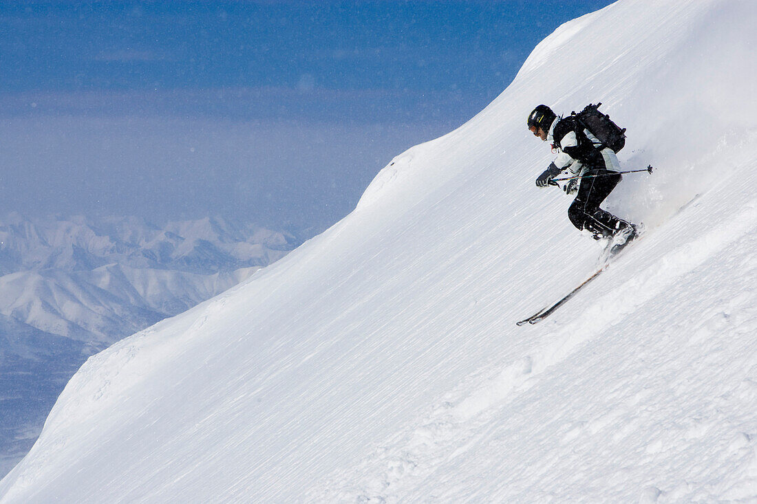 Heliskiing at Kamchatka, Sibiria, Russia, a man skis the powder