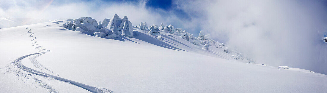 Eine Skispur im Tiefschnee auf dem Gletscher des Mutnovsky, Heliskiing in Kamtschatka, Sibirien, Russland