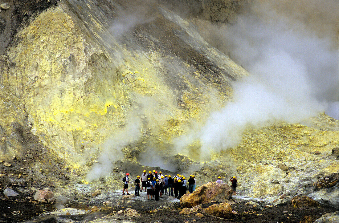 Tourists visiting sulphur fomaroles on White Island, North Island, New Zealand