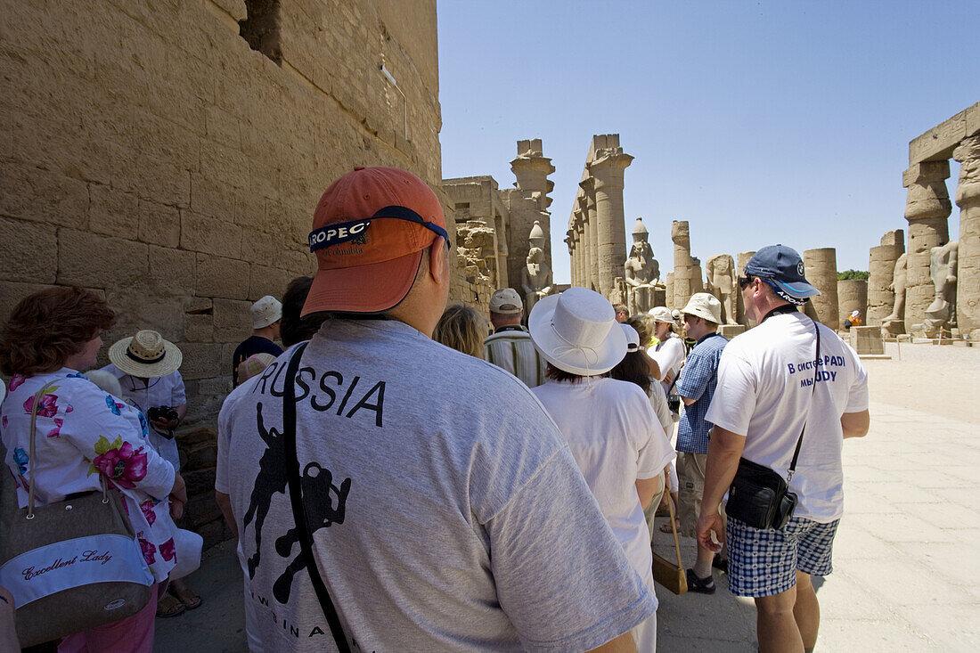 Tourists visiting. Consecrated to God Amon-Re the Luxor temple was built by Amenophis III (1391-1353) , elarged later on mostly by Ramasses II (1279-1213). The temple was linked to Karnak by a 3km alley lined with sphinxes. Luxor. Egypt