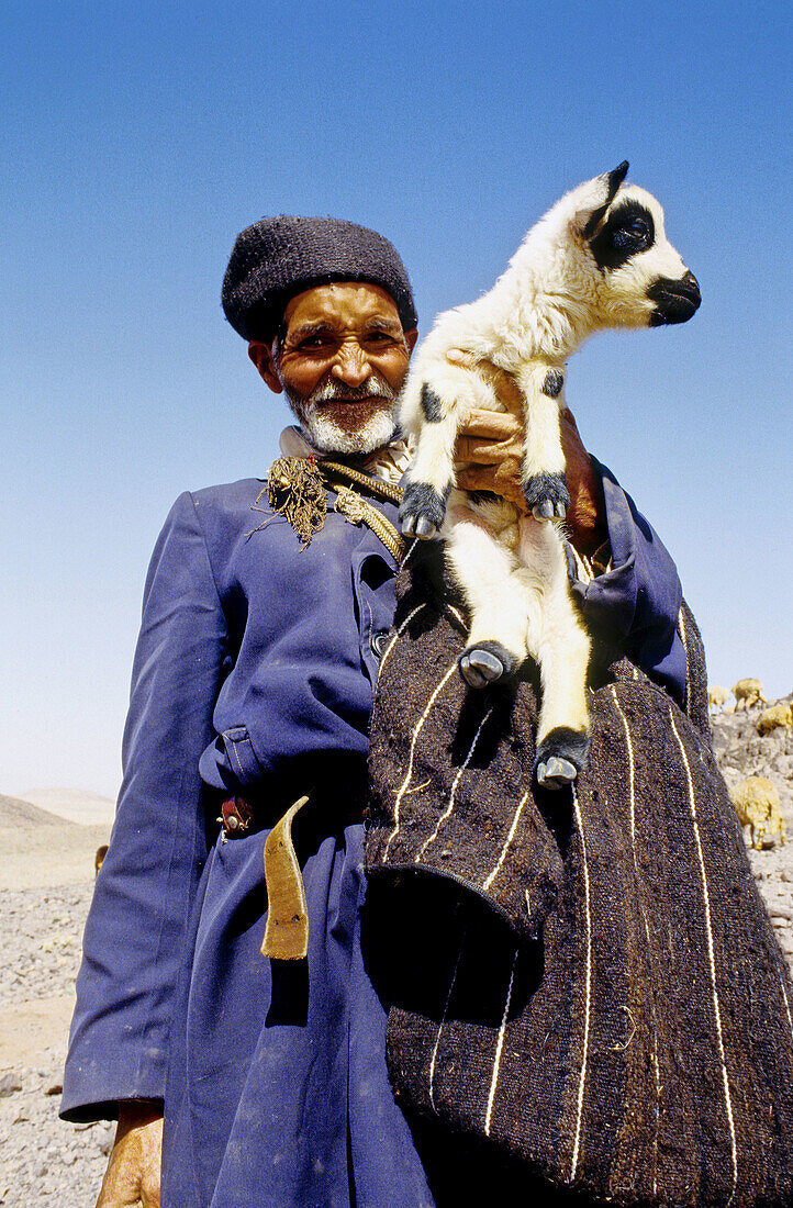 Shepherd and lamb. Dades valley, Atlas mountains, Morocco