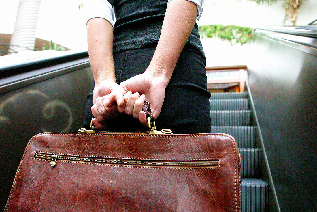  Adult, Adults, Back view, Briefcase, Briefcases, Business, Carry, Carrying, Clasp, Clasping, Color, Colour, Contemporary, Detail, Details, Economy, Escalator, Escalators, Female, Grasp, Grasping, Grip, Gripping, Hold, Holding, Horizontal, Human, Indoor, 