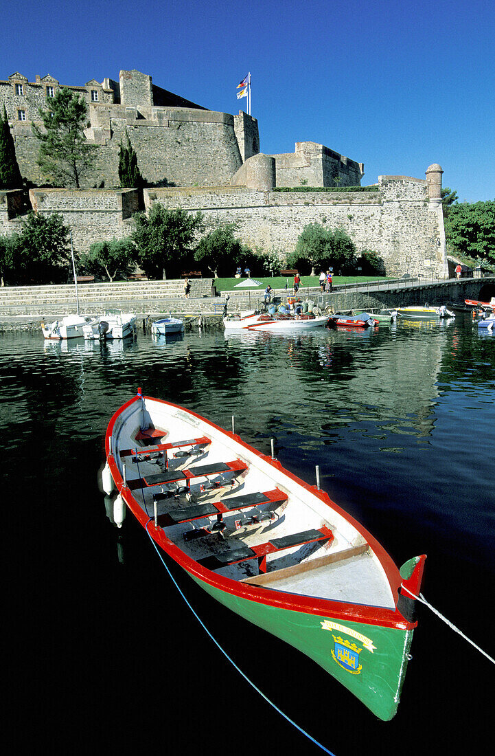 Traditional Catalan boats and Royal Castle in background. Historic Village and Harbour. Colliure. Pyrenees-Orientales. Languedoc Roussillon. France