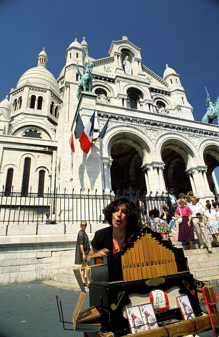 Organ player in front of Sacre Coeur basilica. Montmartre, Paris. France