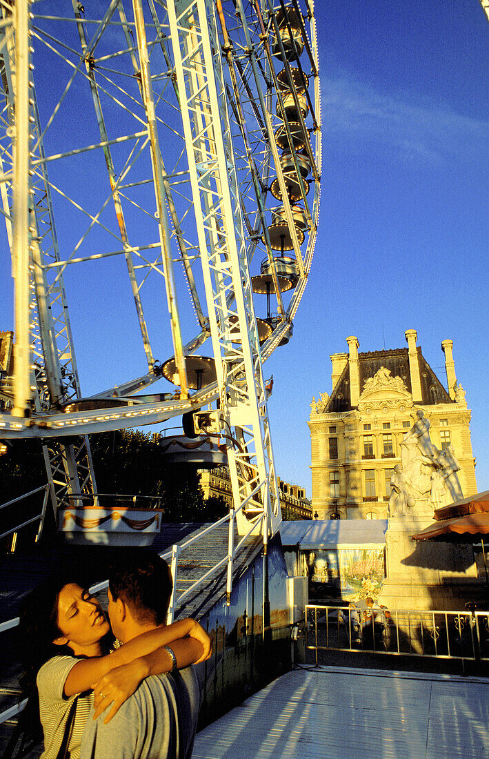 Ferris wheel at Jardin des Tuileries with Louvre in background. Paris. France