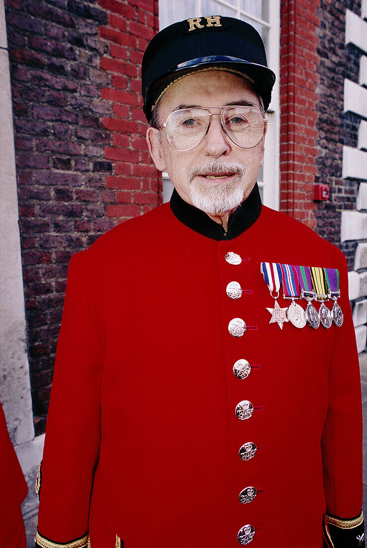 Pensioner in red uniform with medals, Chelsea Royal Hospital. London. England