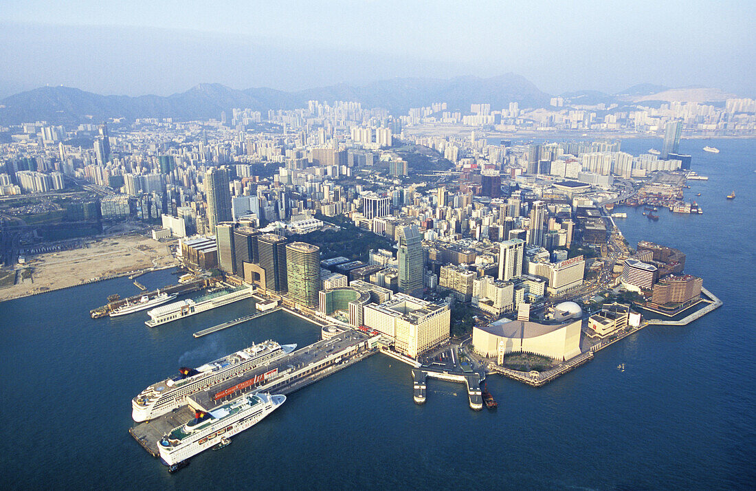 Aerial of Kowloon and liners quay on left. Hong Kong. China