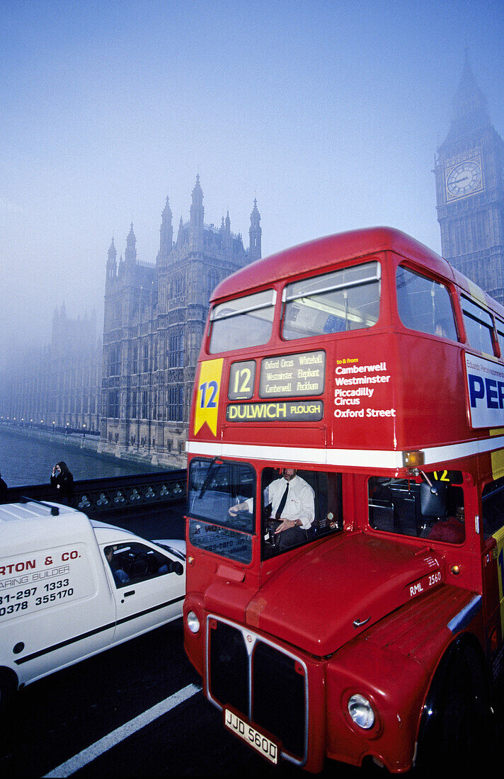 Double-decker red bus on Westminster Bridge in a misty day. London. England