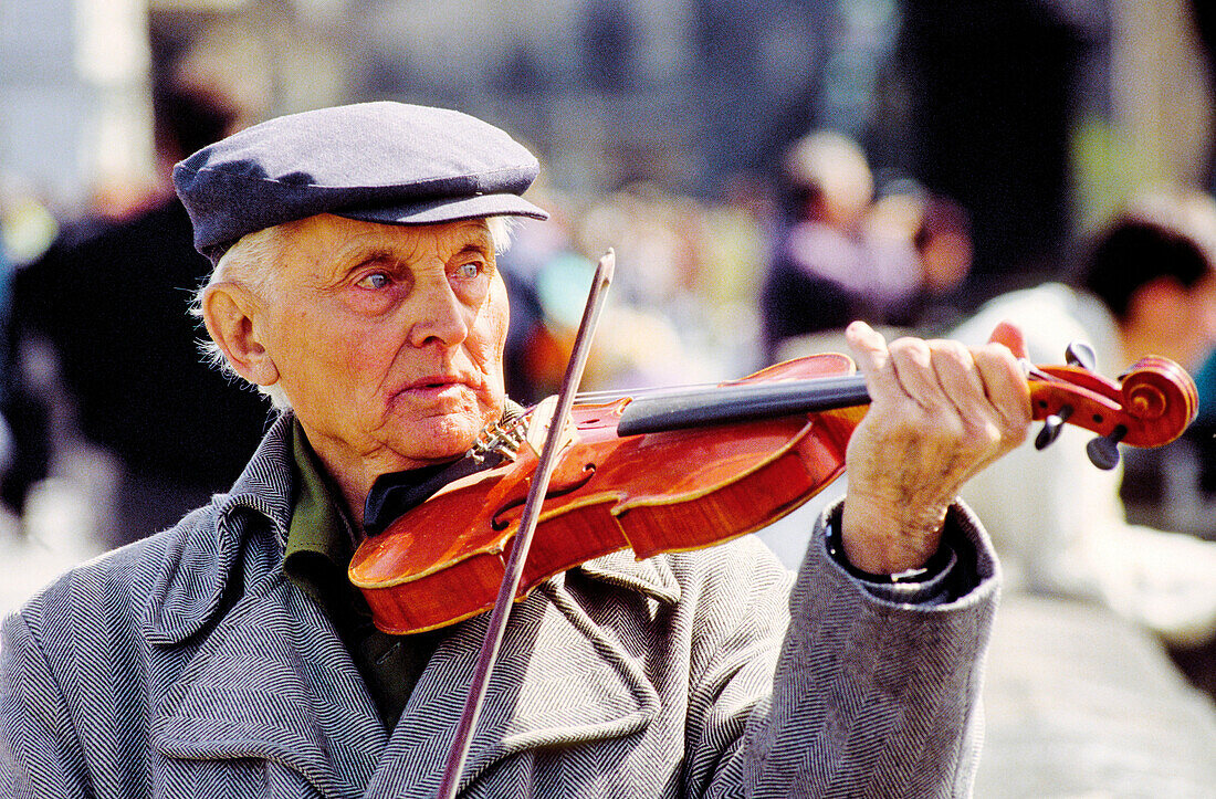 Elderly man playing violin at Charles Bridge. Prague. Czech Republic