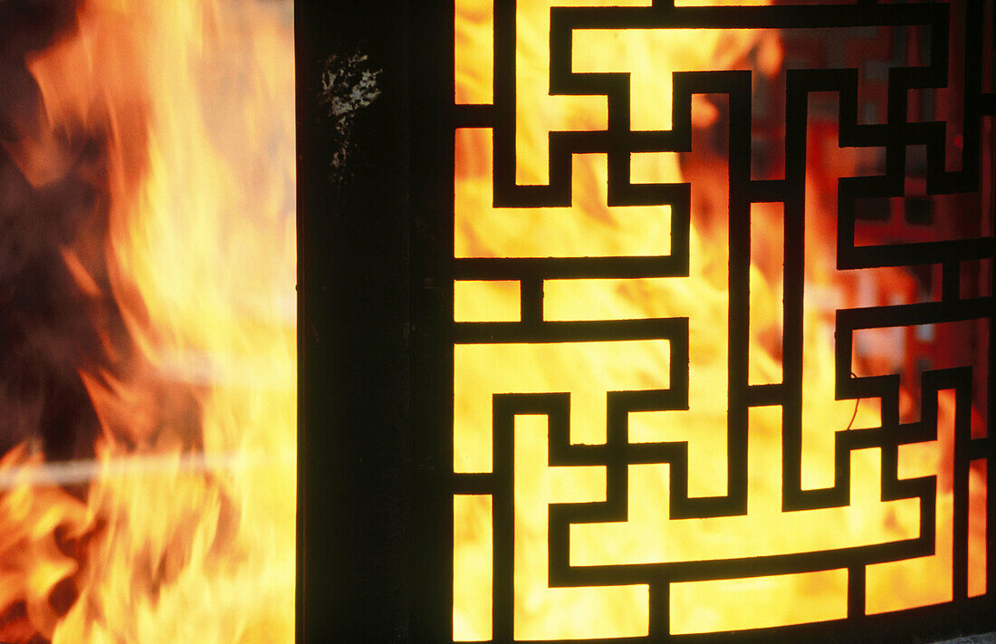 Detail of flames, intimate ceremony for grandfather s death first anniversary at the Jade Buddha temple. Shanghai. China