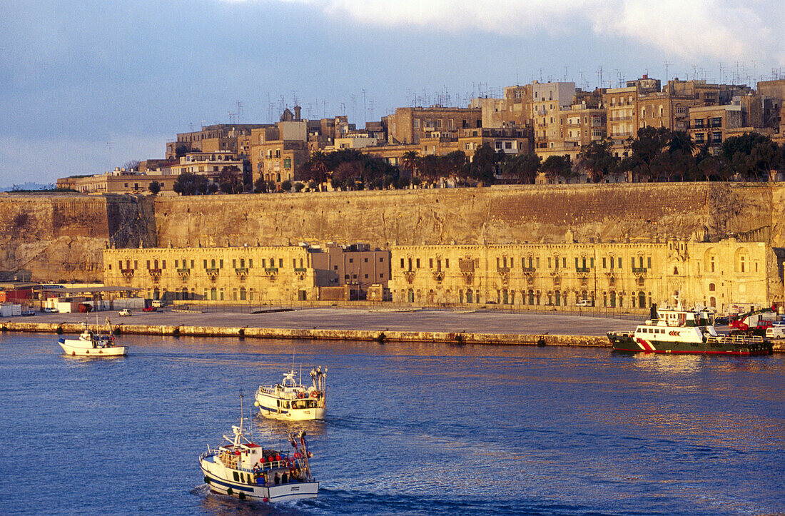 Grand Harbour sunrise, fishing boats returning. Valletta. Republic of Malta.
