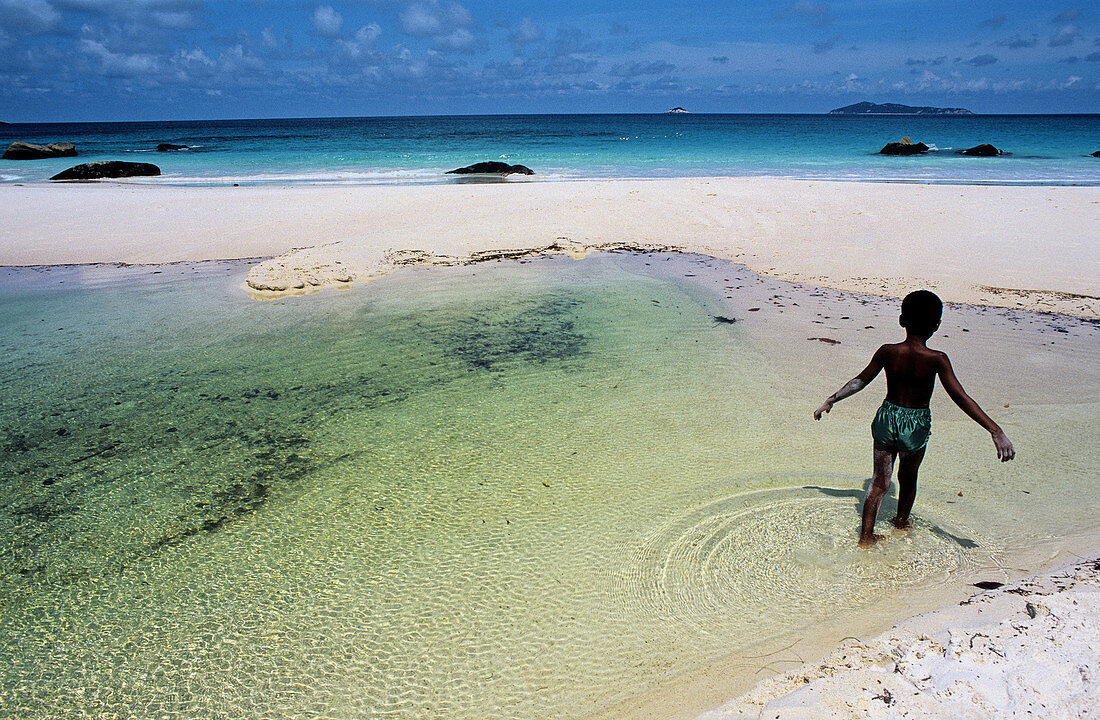 Child in the lagoon. Praslin Island. Seychelles