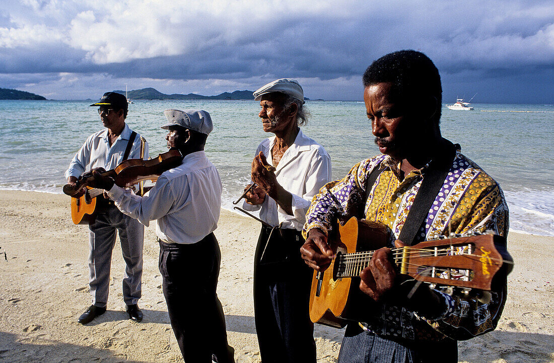 Wedding celebrated on the Achipiel Hotel beach with local musicians. Praslin Island. Seychelles