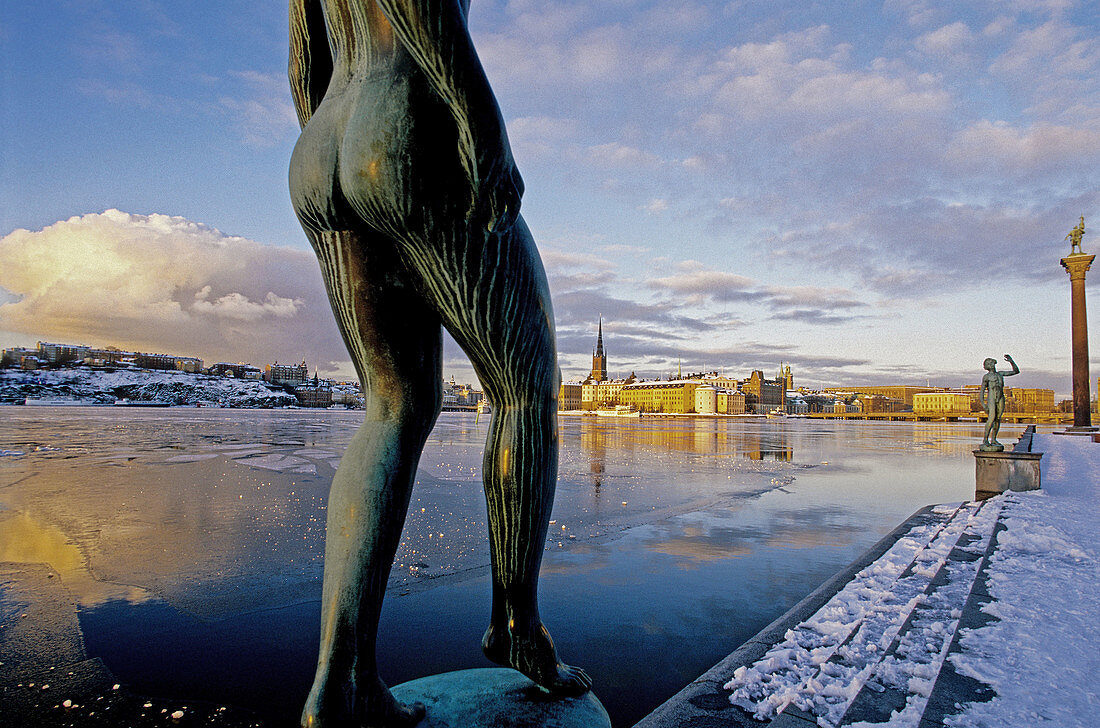 Riddarsholmen, winter view from city hall. Bronze statue of naked woman at fore. Stockholm. Sweden