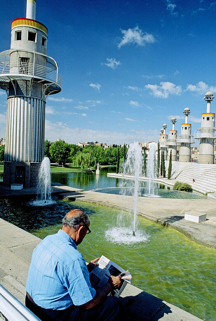 Man reading newspaper at España Industrial park. Barcelona. Spain