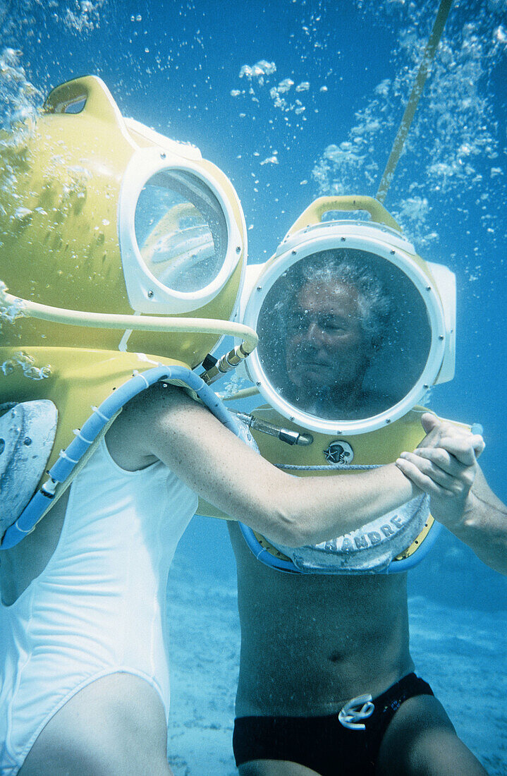 Underwater dance in diving suite. Close to Tahiti, Moorea island in the Windward islands. Society archipelago. French Polynesia (model released)