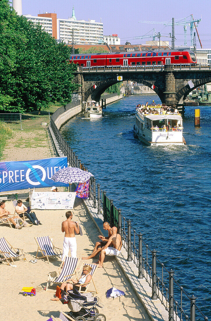 Summer beach and tour boat on Spree River. Berlin. Germany