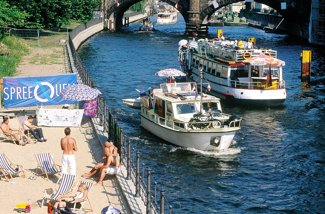 Summer beach and tour boats on Spree River. Berlin. Germany