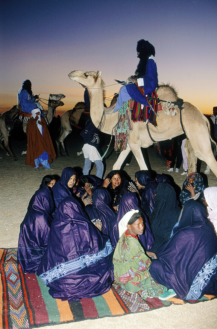Female tuaregs singing at dusk in a festival near Tamanrasset. South Sahara. Algeria