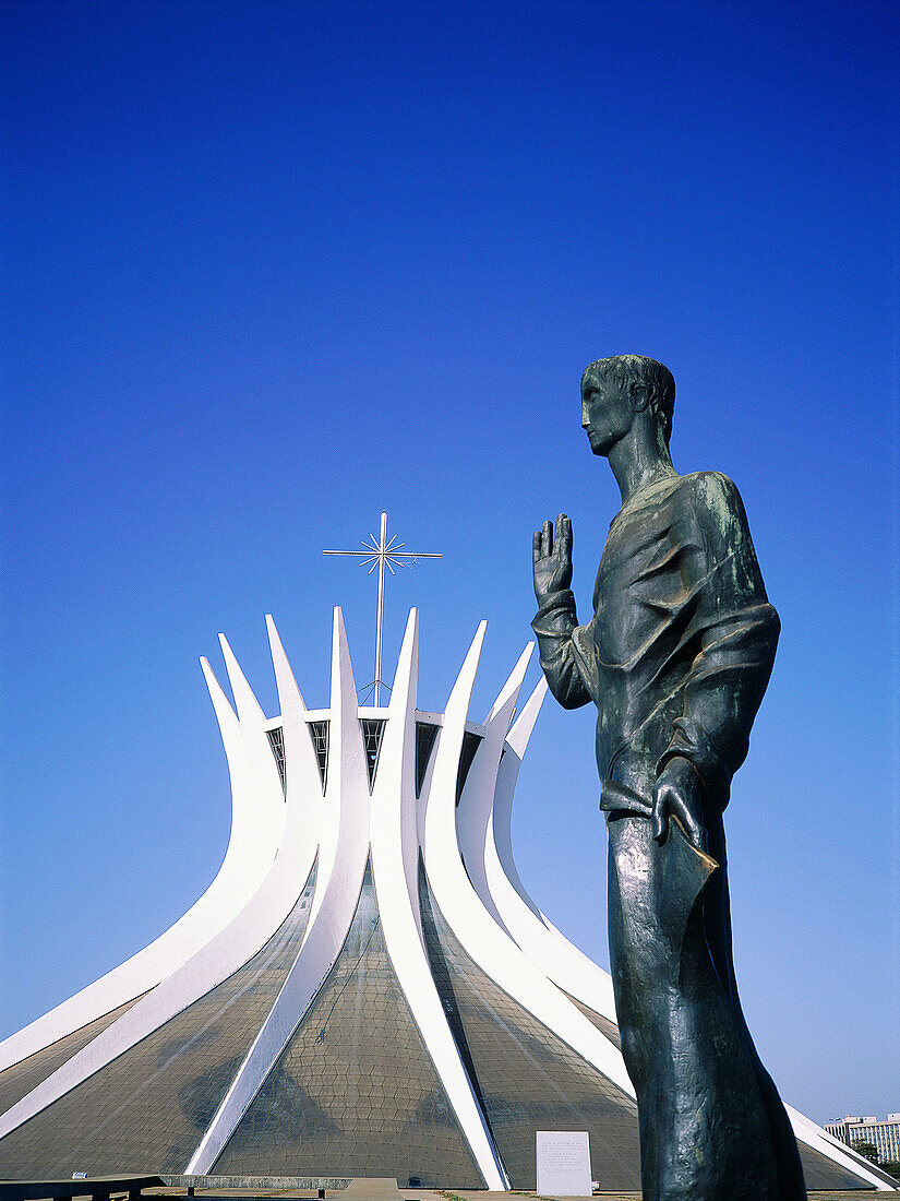 Statue in front of the cathedral designed by architect Oscar Niemeyer. Brasilia. Brazil