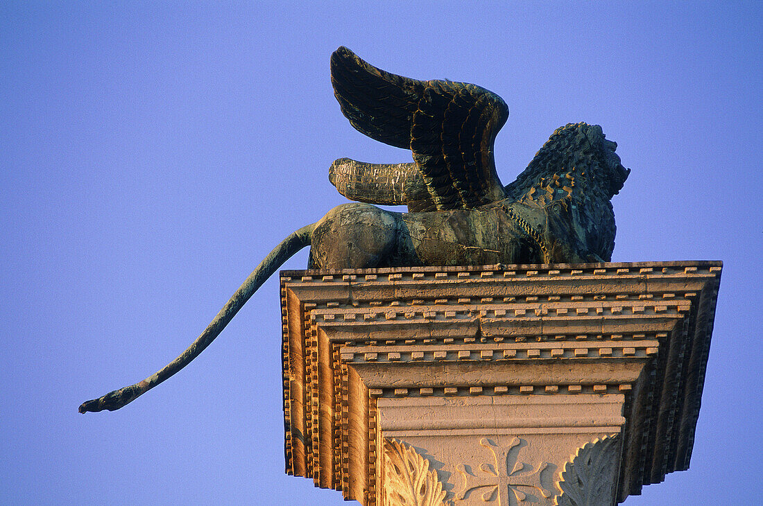 Brass lion, symbol of Veneto, on top a column in St. Mark s Square. Venice. Italy
