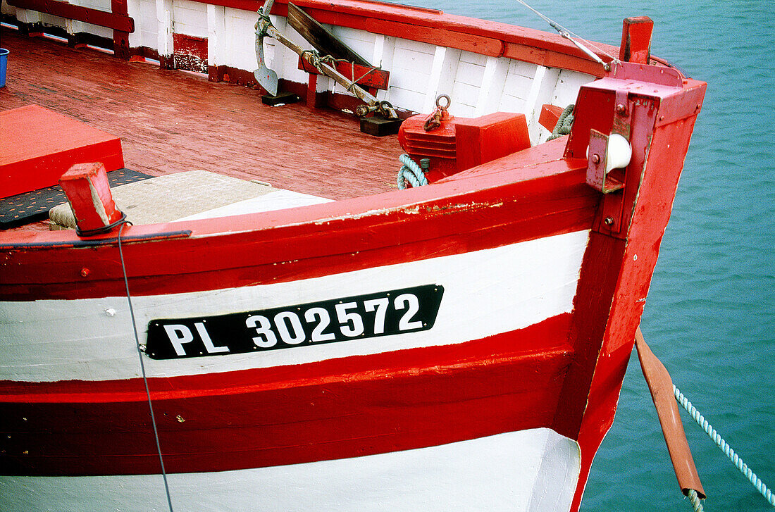 Close-up on a fishing boat painted in red. Cotes d Armor. Brittany. France