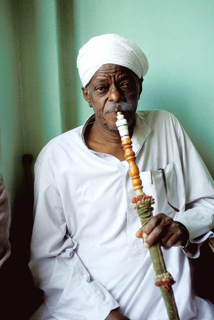 Man smoking a water pipe. Luxor. High Egypt. Egypt