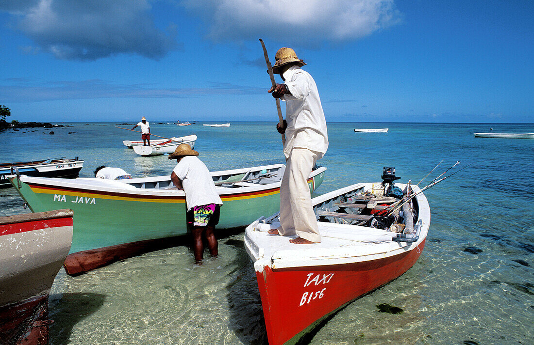 Local small fishing boats delivering fish to the market. Trou Aux Biches Beach. Mauritius