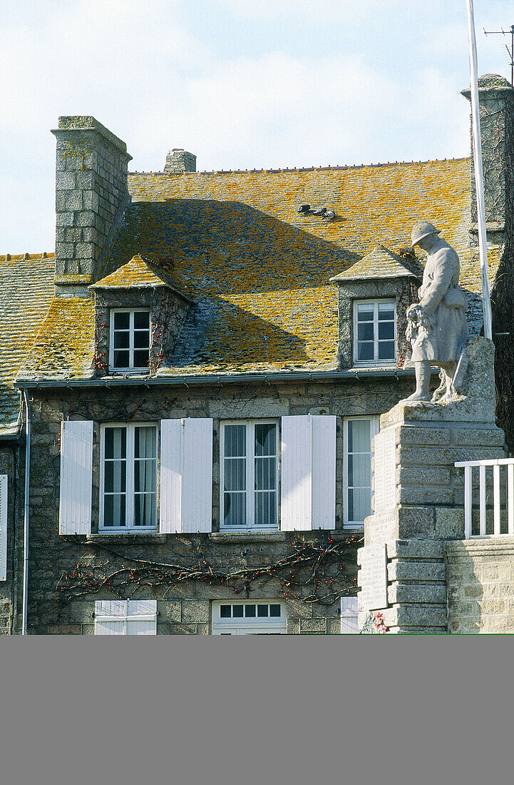 Old granite stone house and War Memorial. Barfleur. Manche. Normandy. France