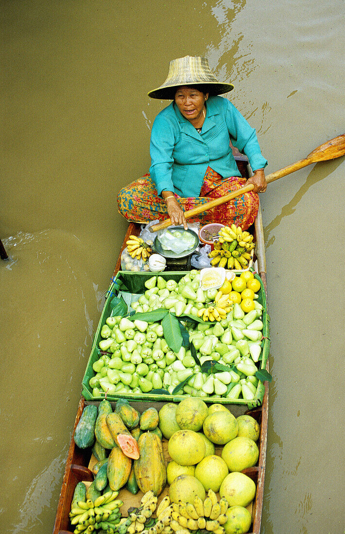 Vegetables seller on a small boat. Damnoek Saduak Floating Market. Bangkok. Thailand