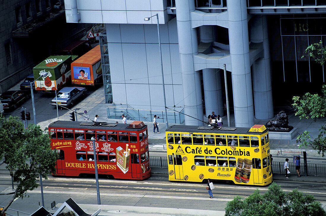 Elevated view on two trams with ad painted on. Wanchai, Hong Kong. China