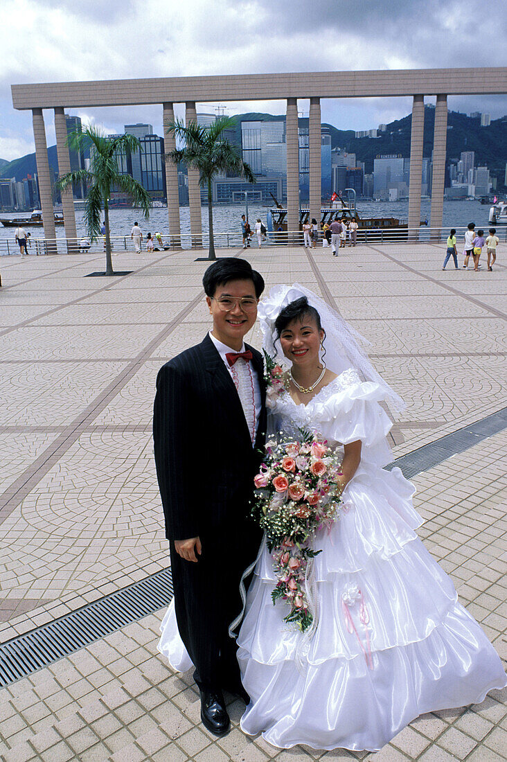 Just married couple on the waterfront promenade. Kowloon, Hong Kong. China