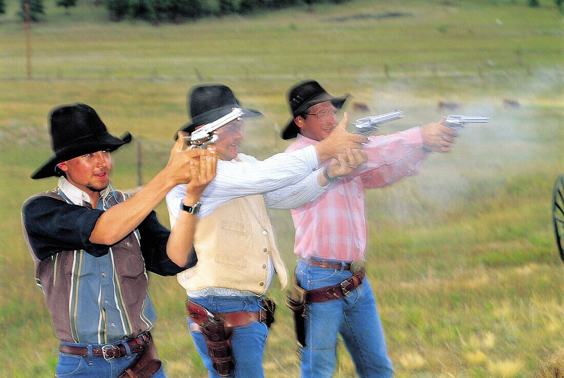 Cowboys firing for fun. Colorado. USA