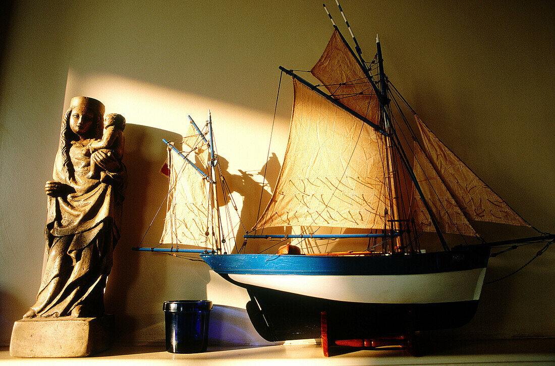 Scale model of local ancient fishing boat and Virgin statue. Cancale. Ille-et-Villaine. Brittany. France
