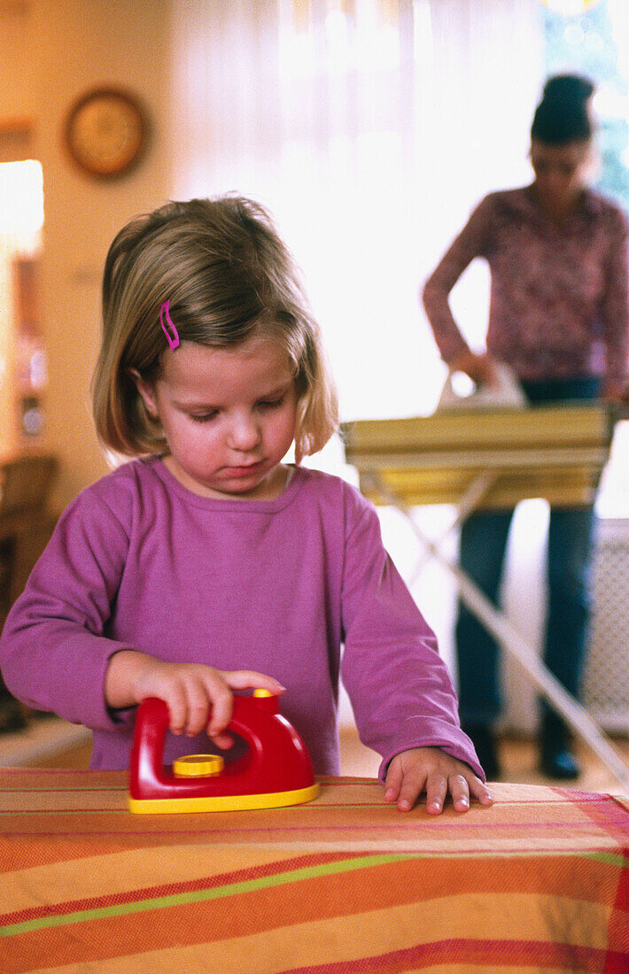 Little girl, ironing