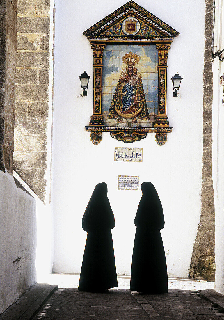 Cobijadas (ladies dressed in black) in front of Virgen de la Oliva mosaic at Véjer de la Frontera. Cadiz province. Spain